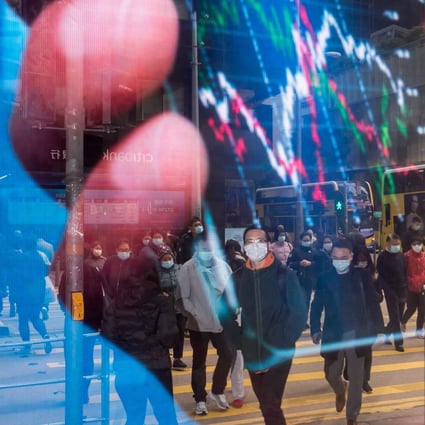 Pedestrians in Hong Kong are reflected in an advertisement. Photo: Bloomberg