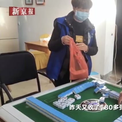 Police confiscate mahjong tiles as they enforce the order that people refrain from playing. Photo: Weibo