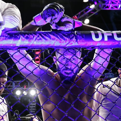 Dominick Reyes rests on the fence after his light heavyweight title fight against Jon Jones at UFC 247. Photos: AP