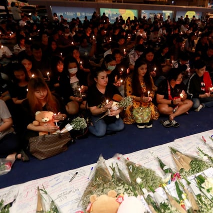 People gather as they pray for victims who died in a mass shooting at Terminal 21 shopping mall in Nakhon Ratchasima. Photo: Reuters