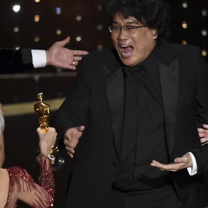 Bong Joon-ho reacts as he is presented with the Oscar for best picture for Parasite by actress Jane Fonda at the Academy Awards ceremony at the Dolby Theatre in Los Angeles. Looking on from left is the film’s star Song Kang-ho. Photo: AP