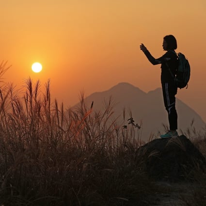 A hiker enjoys the view at Sunset Peak, Hong Kong. Exercising outdoors helps to reduce anxiety and depression. Photo: Felix Wong