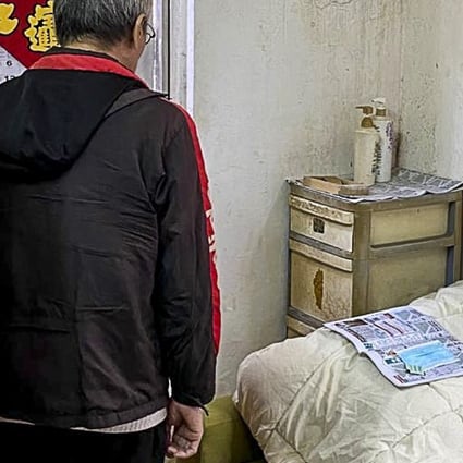 An elderly low-income resident uses newspaper to store his used mask, hoping it can absorb some of the moisture before reuse. Photo: Kwai Chung Subdivided Flats Residents’ Alliance