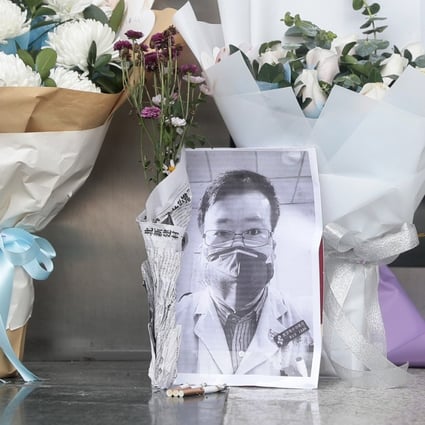 Floral tributes to Li Wenliang stand outside Wuhan Central Hospital in Wuhan, Hubei province, on Friday. Photo: EPA-EFE