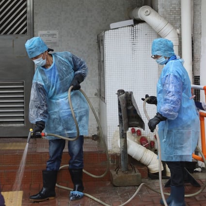 Health workers disinfect a public walkway near Hong Mei House in Cheung Hong Estate in Tsing Yi. Photo: Sam Tsang