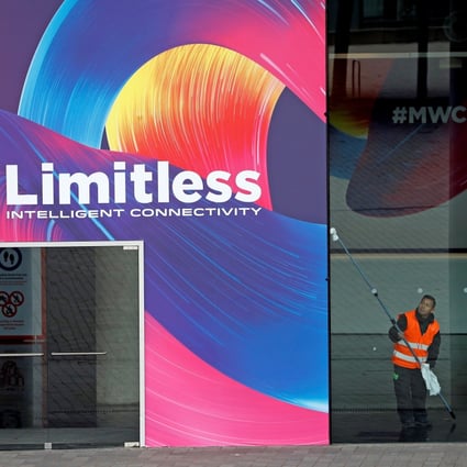 An operator cleans up a window at the entrance of the Fira Gran Via, venue for the MWC Barcelona trade show. Photo: EPA-EFE