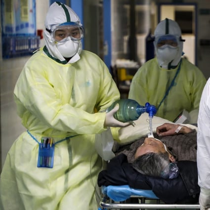 Medical workers transfer a patient in the isolation ward for coronavirus patients at a hospital in Wuhan, the epicentre of the outbreak. Photo: AP