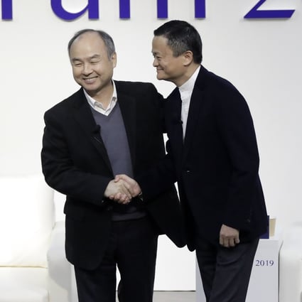 Masayoshi Son, chairman and chief executive officer of SoftBank Group, left, and Jack Ma, former chairman of Alibaba Group Holding, shake hands at Tokyo Forum 2019 on December 6, 2019. Photo: Bloomberg