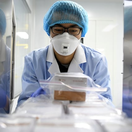 A researcher delivers detection reagents for the new coronavirus at a company in Tianjin, China. Photo: Xinhua