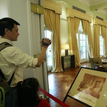 A visitor takes a picture of the drawing room in Government House. In Hong Kong, ‘safe’ interior tastes have always been what sells the best. Photo: SCMP