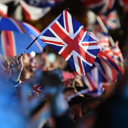 Brexit supporters wave Union flags in Parliament Square, London. Photo: AFP