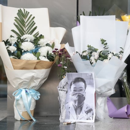 Tributes to Li Wenliang lie outside Wuhan Central Hospital in Wuhan, Hubei province, a day after his death. Photo: EPA-EFE
