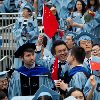 Graduates wave Chinese flags during a commencement ceremony at Columbia University in New York on May 16, 2018. Photo: Xinhua