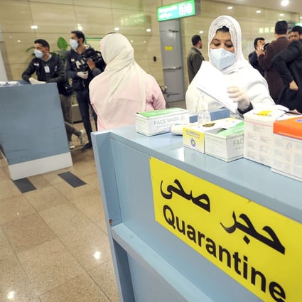 Egyptian quarantine officers prepare to screen travellers arriving at Cairo’s airport. The country has reported its first coronavirus case. Photo: AFP