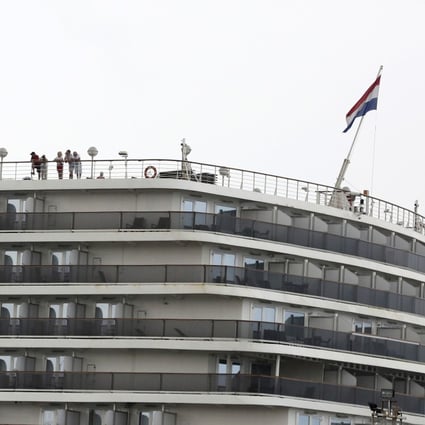 Passengers stand on the top deck of the MS Westerdam while the cruise ship is docked in Sihanoukville, Cambodia. Photo: AP