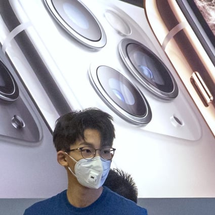 Employees wear face masks as they stand in a reopened Apple Store in Beijing on Friday. Photo: AP