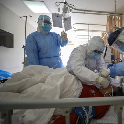 Medical workers treat a new coronavirus patient in Wuhan, still the focal point of the outbreak. Photo: AP