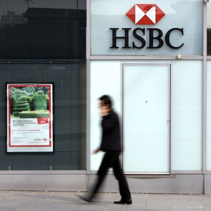 In this file photograph taken on March 24, 2010, a pedestrian walks past a branch of international banking firm HSBC in Paris. Photo: AFP