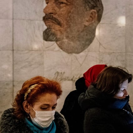 A woman wearing a face mask walks in a metro station in Moscow on February 7. Photo: AFP