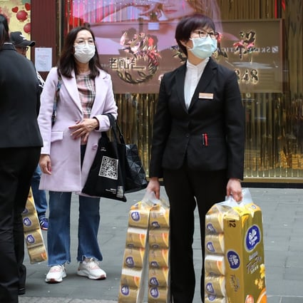 Shoppers seen with bags of toilet paper in Causeway Bay. Hongkongers have been snapping up surgical masks, health care products and toilet paper rolls amid the coronavirus outbreak. Photo: Xiaomei Chen