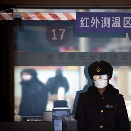 A station worker in face mask and goggles waiting to check passengers’ tickets at Beijing railway station. Travel restrictions are in place across much of China as authorities battle to contain the coronavirus. Photo: AP