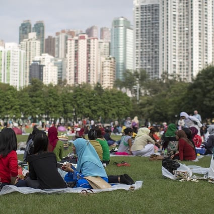 Migrant workers in Hong Kong’s Victoria Park during their day off. Photo: Bloomberg