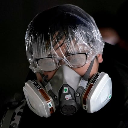 A man outside the Shanghai railway station wears a mask and other protective gear. Photo: Reuters
