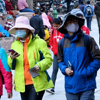 Pedestrians wearing face masks in Kathmandu. Photo: AFP