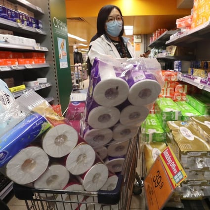 A shopper stocks up on toilet rolls at a supermarket in Hong Kong on February 5 amid fears over the coronavirus outbreak. Photo: Nora Tam
