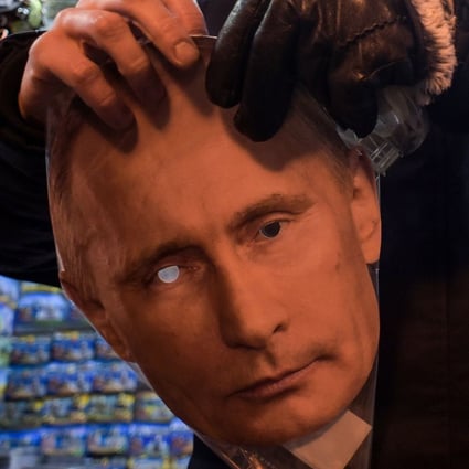 A mask of President Vladimir Putin on sale among other items at a souvenir stall in St Petersburg. Photo: AFP