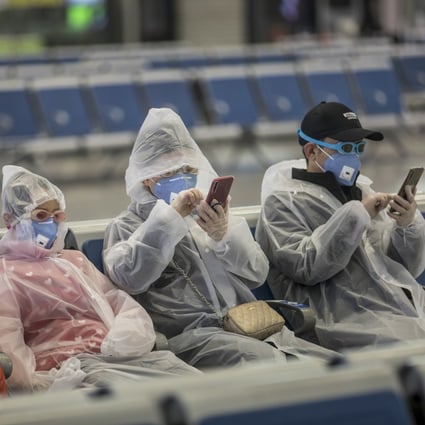 A family wearing masks and makeshift protection gear wait for their train at the Hongqiao high-speed railway station in Shanghai on February 11. More than 75,000 cases of coronavirus infection have so far been reported with over 2,000 deaths. Photo: Bloomberg