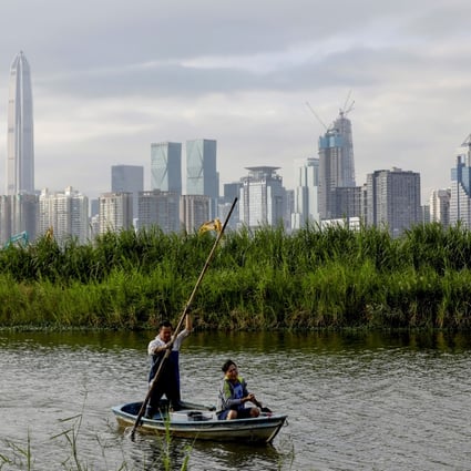 Hongkongers return from a fishing trip to their home in Lok Ma Chau in Hong Kong, with the Shenzhen skyline in the distance, on October 29, 2019. Photo: Reuters
