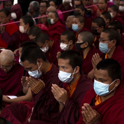 Buddhist monks wear protective masks at a mass prayer meeting for victims of the coronavirus in Kathmandu, Nepal. Photo: EPA-EFE