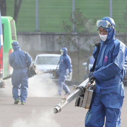 Workers spray disinfectant at a public bus terminal in Seoul. Photo: Agence France-Presse