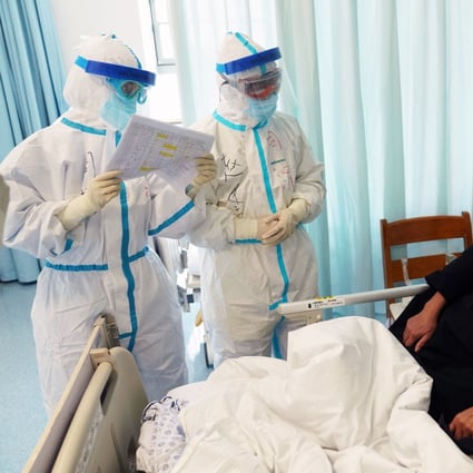 Respiratory and critical care specialists check up on a patient at Wuhan’s Tongji Hospital. Photo: Xinhua