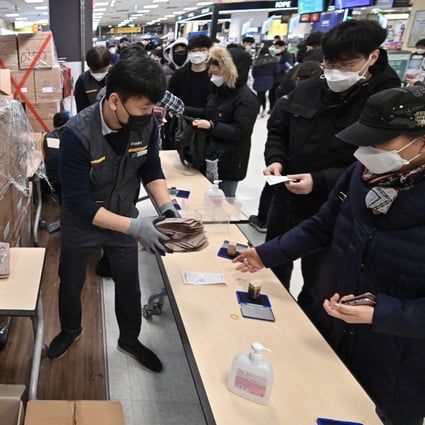 People buy face masks in the South Korean city of Daegu on Tuesday. The country has reported more than 900 coronavirus cases – the most outside China. Photo: AFP