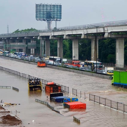 Motorists trapped on a flooded tollway after heavy rain. Photo: AFP
