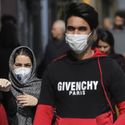 Pedestrians in Tehran wear masks amid an outbreak of coronavirus in Iran. Photo: AP