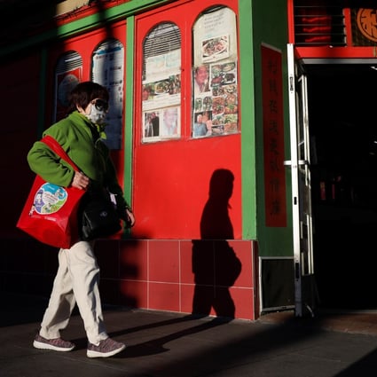 A woman wearing a face mask walks through San Francisco’s Chinatown. Photo: Reuters