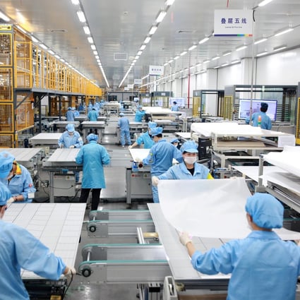 Employees on a photovoltaic solar panel assembly line at Risen Energy in Ningbo in Zhejiang province on February 21, 2019. Zhejiang Daily via Reuters