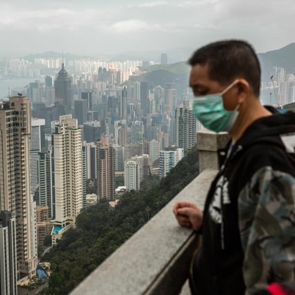 People wearing protective face masks visit the lookout of Victoria Peak on February 25. Gilead Sciences plans to expand clinical studies of remdesivir, its antiviral drug for the treatment of Covid-19, in Hong Kong, South Korea, Taiwan and Singapore. Photo: Agence France-Presse