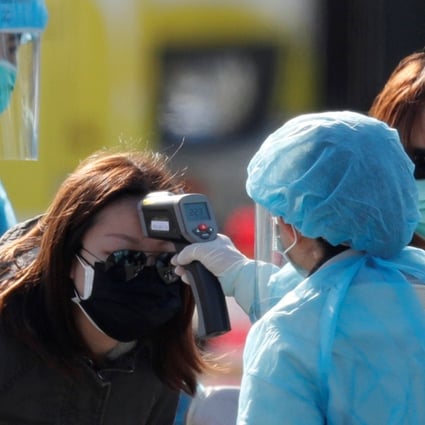 A passenger has her body temperature taken upon leaving the coronavirus-hit cruise ship Diamond Princess in Yokohama. Photo: Reuters