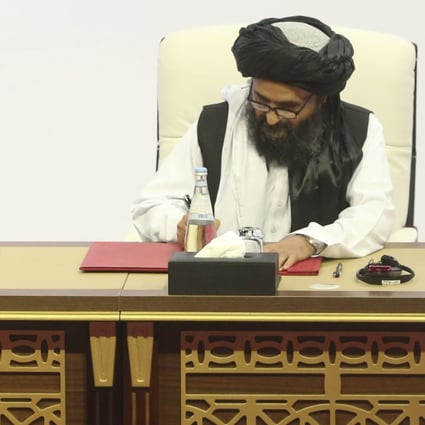 US peace envoy Zalmay Khalilzad, left, and Mullah Abdul Ghani Baradar, the Taliban group's top political leader sign a peace agreement between Taliban and US officials in Doha, Qatar on February 29. Photo: AP