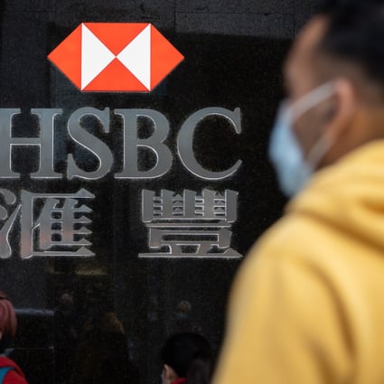 Pedestrians in protective masks walk past an HSBC branch in Hong Kong’s Central district. Hong Kong, the bank’s largest market, has been hit hard by months of anti-government protests and the coronavirus epidemic. Photo: EPA-EFE