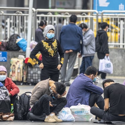 Uygurs wearing face masks pictured outside a railway station in Guangzhou last month. Photo: EPA
