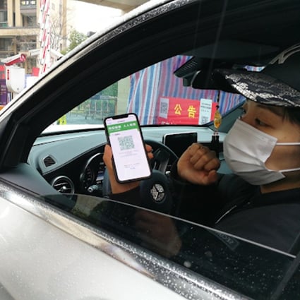 A driver showing his green health code to enter an apartment complex in China. Photo: Handout
