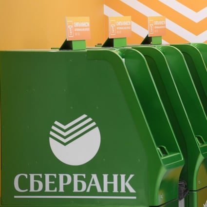 A man stands by Sberbank cash machines at Moscow's Sheremetyevo airport terminal B. Photo: AFP