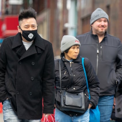 A man wearing a mask walks down a street in Chinatown in New York. Photo: Bloomberg