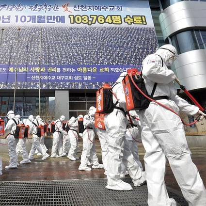 Soldiers in protective suits disinfect the area outside a Shincheonji church in Daegu, South Korea, on March 1, as Covid-19 cases outside China surge. Photo: AP