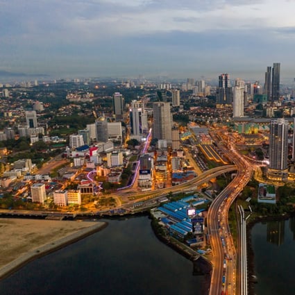 Skyscrapers and buildings illuminated at dawn on the skyline in Johor Bahru, Malaysia. Photo: Bloomberg